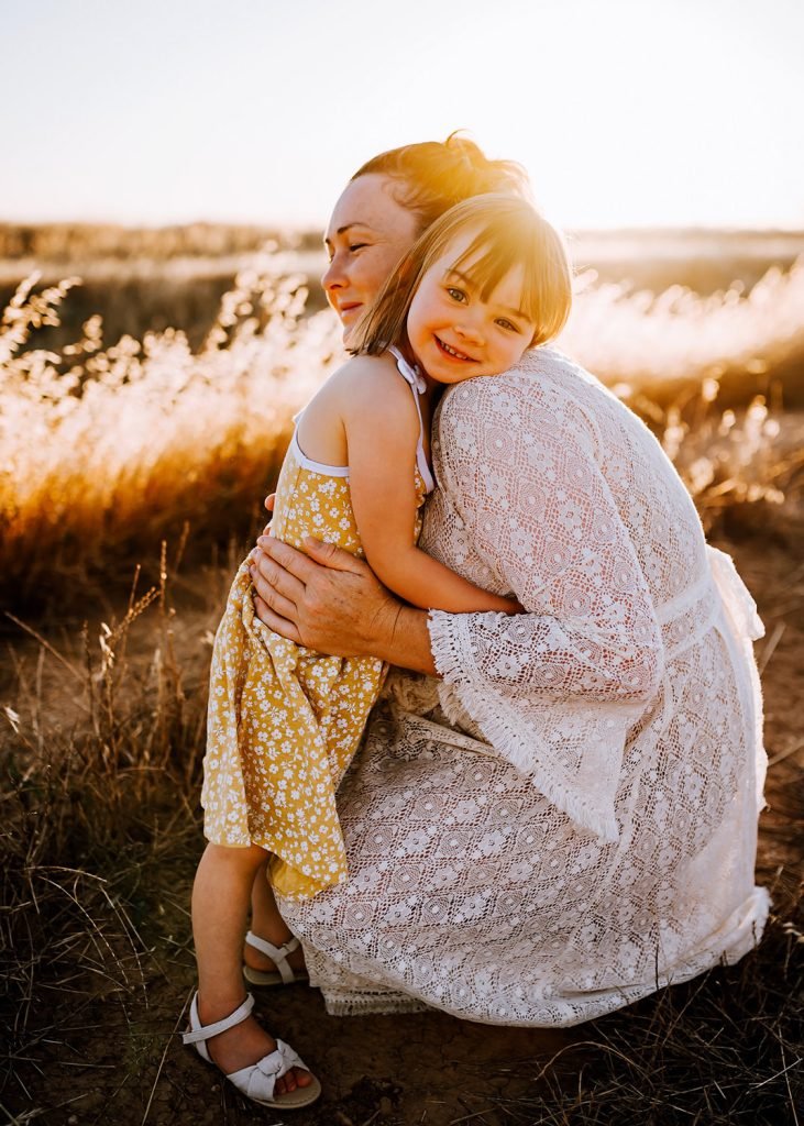 Field family photoshoot at sunset